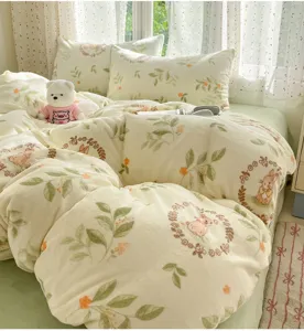 Milk velvet bedding set detail view showing cozy winter coral fleece duvet cover and pillows.