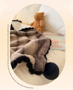 Close-up view of the plush rabbit velvet throw blanket showing soft texture and cute black balls.