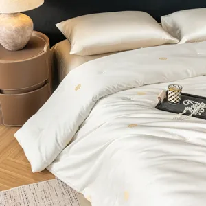 Luxurious silk quilt detail with elegant embroidery, soft and skin-friendly bedding.