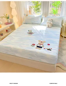 Soft cotton fitted sheet with cute rabbit embroidery and blue watercolor print for bedroom.