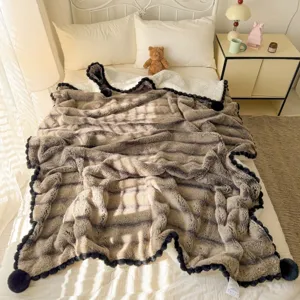 Cozy faux fur throw blanket with pom pom border, soft fluffy plush bed blanket for single bed.