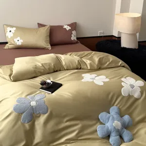 Detailed view of 100S long-staple cotton towel embroidery bedding set with floral design.