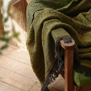 Jacquard cotton throw blanket detail, vintage fringe design for cozy sofa decor and warm nap.