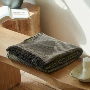 Close-up of vintage cotton jacquard throw blanket texture with elegant fringe and pattern