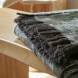 Vintage cotton jacquard throw blanket detail showing soft fringe and textured pattern.