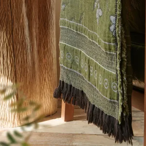 Detailed view of vintage jacquard cotton throw blanket with fringe, cozy sofa blanket.