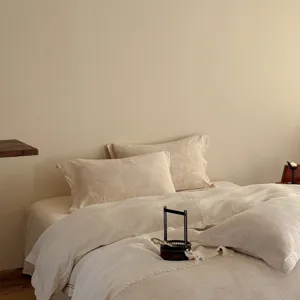 Close-up detail of wabi-sabi style cotton linen bedding set with delicate jacquard texture.