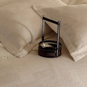 Close-up detail of beige cotton linen jacquard bedding, textured wabi-sabi aesthetic style.