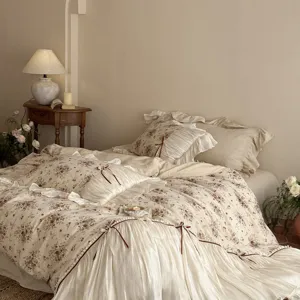 French vintage cotton linen floral bedding set detail showing romantic bow and ruffle duvet.