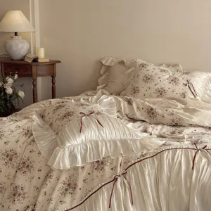 French vintage floral duvet cover set with romantic ruffles and ribbon bows for cozy bedroom.