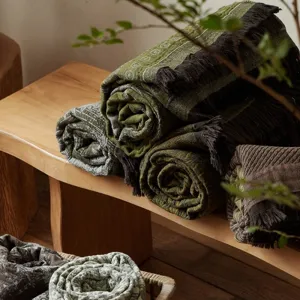 Vintage cotton jacquard throw blanket with stylish fringe for cozy sofa and bed use.