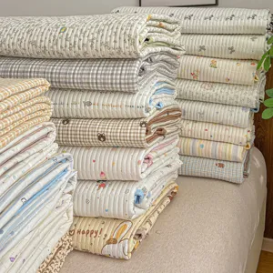 Detailed view of quilted cotton bedspreads and quilt covers with various cute cartoon prints.