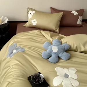 Luxury 100S long-staple cotton bedding set with elegant 3D floral embroidery for bedroom decor.