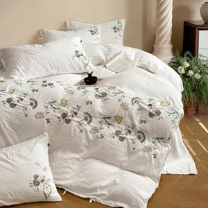 Parure de lit luxueuse en coton brodé de fleurs, housse de couette et drap doux pour la chambre.