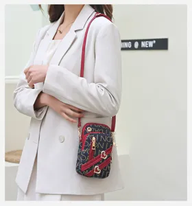 Womens small crossbody phone bag with monogram pattern and heart charms detail for daily.