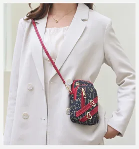 Mini crossbody phone bag for women, stylish vertical PU leather purse with cute heart charms.