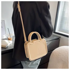 Detail view of stylish cream shoulder bag, elegant retro top handle design for women daily wear.