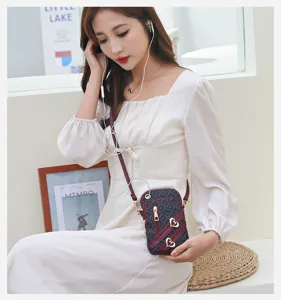 Women crossbody phone bag mini vertical shoulder bag stylish monogram design with heart decor.