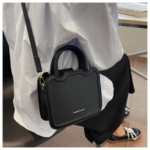Trendy black top handle crossbody bag for women, stylish structured casual shoulder bag.