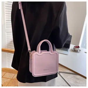 Detailed view of the trendy light purple women's crossbody bag with elegant structured design.