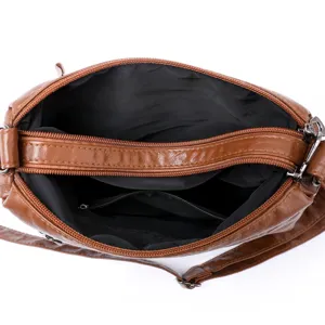 Women brown washed leather crossbody shoulder bag with multi-pocket zippers main view.