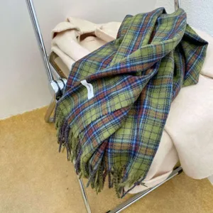 Cozy green plaid scarf for women winter, stylish tassel design, warm and soft fashion accessory.