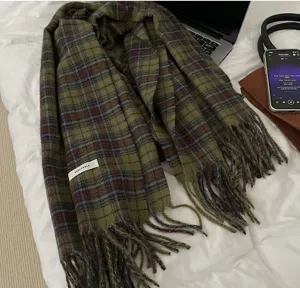 Cozy green plaid winter scarf detail shot, soft fringe design, stylish seasonal accessory.