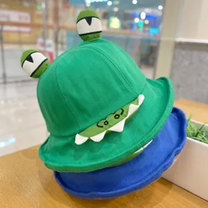 Detailed shot of cute green bucket hat with funny 3D big eyes and embroidered teeth design.