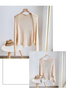 Detailed view of beige hollow-out knit shrug, featuring breathable honeycomb mesh texture.