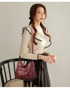 Detailed view of women's soft leather crossbody shoulder bag with multi pockets and adjustable strap.