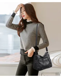 Close-up of women's soft leather crossbody shoulder bag with multi-pocket design, daily wear.
