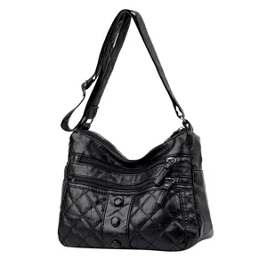 Stylish black soft leather shoulder bag with quilted design and multiple zipper pockets.