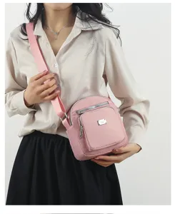 Pink nylon women crossbody shoulder bag, lightweight multi-layer casual daily purse.