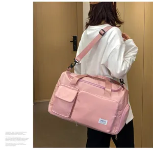 Bolso de viaje plegable rosa con gran capacidad, correa de hombro y varios bolsillos.