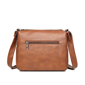 Detailed view of the brown soft leather crossbody bag, featuring a back zipper pocket.
