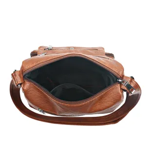 Detailed view of women soft leather crossbody shoulder bag interior structure and zipper.