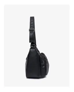Black faux leather shoulder bag side detail showing multiple zip pockets and adjustable strap.