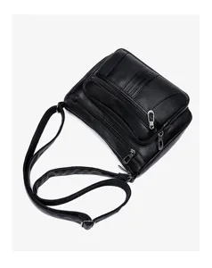Detail view of black washed soft leather crossbody bag featuring multiple zippers and long strap.