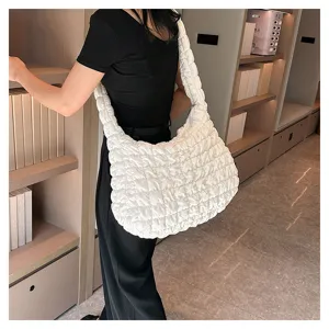 Detail view of a stylish white quilted cloud shoulder bag, soft puffer tote for daily wear.