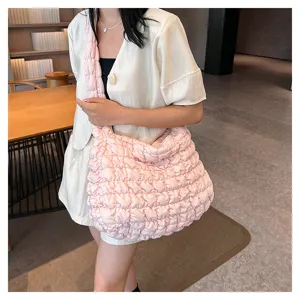 Detailed view of the stylish pink quilted puffer shoulder bag, large capacity casual tote.