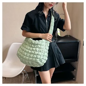 Detail shot of the quilted puffer shoulder bag showcasing soft texture and large capacity.