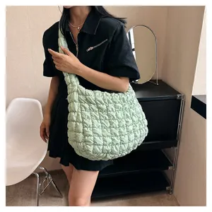 Detailed view of the trendy light green quilted puffer shoulder bag, casual large capacity tote.