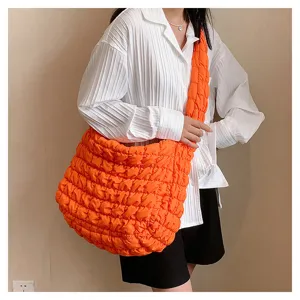 Fashionable orange puffer shoulder bag detail, casual large capacity quilted tote for women daily.