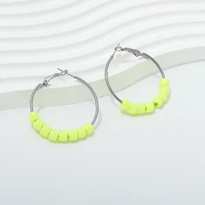 Close-up of 4cm gun black hoop earrings featuring neon yellow beaded charms for women fashion.