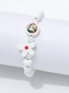 Witte kraalstretcharmband met bloemhanger en ronde bedel met religieus portret voor dagelijks.