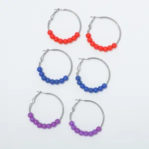 Detailed view of handmade beaded hoop earrings with colorful decorative beads, chic style.