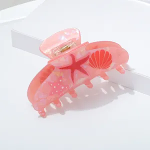 Pink acrylic hair claw clip with cute starfish and shell patterns, summer ocean style accessory.