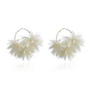 Gedetailleerd overzicht van witte chiffon bloemoorringen met delicate stoffen lagen.