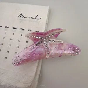 Rhinestone starfish hair claw, resin shark clip, elegant hair accessory detail shot.