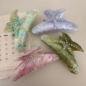 Resin starfish hair claw detail shot, sparkling rhinestone embellishment, multi-color set.